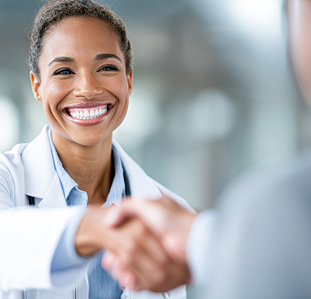 A photorealistic portrait of a smiling mixed race doctor and healthcare consultant shaking hands, trust and medical partnership emphasized, clean clinical background, shot with a Fujifilm GFX 100, 63mm f/2.8 lens, elegant neutral palette --chaos 20 --ar 3:2 --quality 2 --raw --v 7 Job ID: 5449a73f-d37e-4d09-aa84-f7d3e5e3fde3